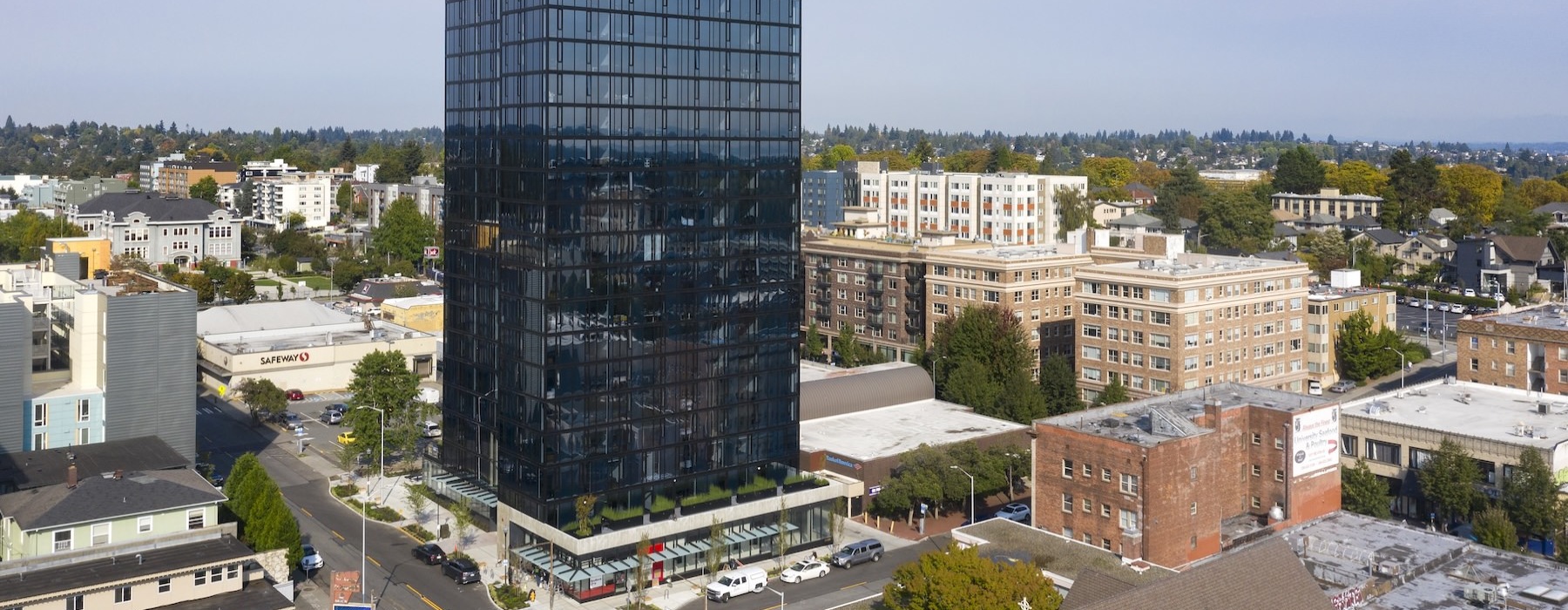 a tall glass building in a city