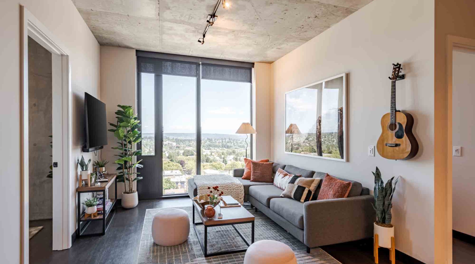 The M model apartment in Seattle with floor to ceiling windows in the living room looking out at the Seattle city views.