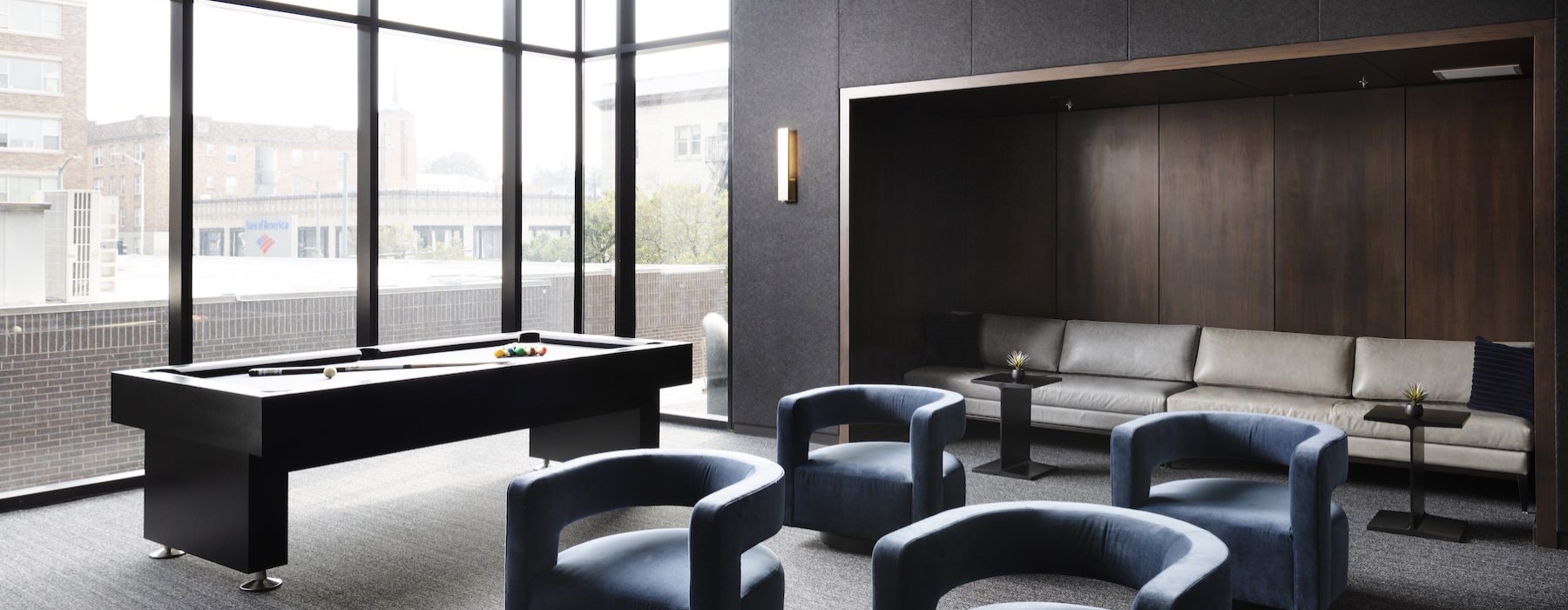 a clubroom with a table and chairs